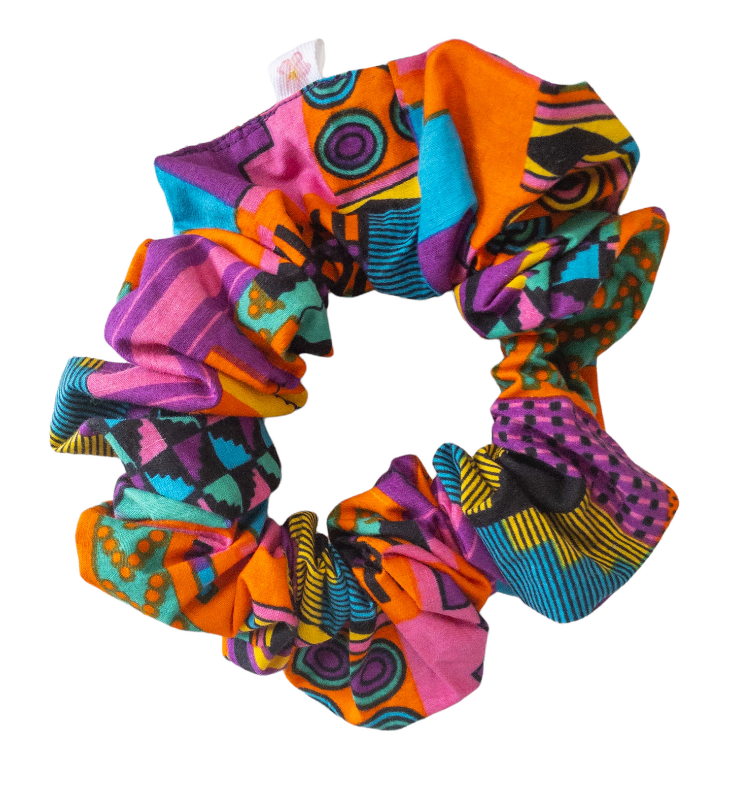 Hair scrunchie with purple and other multi colors such as pink, orange, yellow, blue, and black geometric shape printed kente cloth.