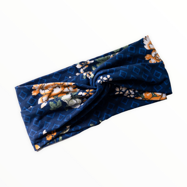 "Navy blue headband, light blue diamond outline shapes on double brushed polyester knit fabric, flowers are combination of golden yellow and white."