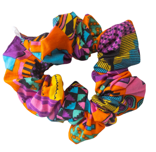 Hair scrunchie with purple and other multi colors such as pink, orange, yellow, blue, and black geometric shape printed kente cloth.