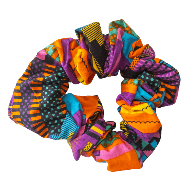 Hair scrunchie with purple and other multi colors such as pink, orange, yellow, blue, and black geometric shape printed kente cloth.