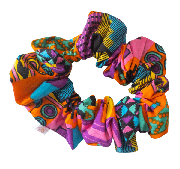 Hair scrunchie with purple and other multi colors such as pink, orange, yellow, blue, and black geometric shape printed kente cloth.
