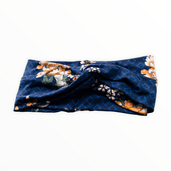 "Navy blue headband, light blue diamond outline shapes on double brushed polyester knit fabric, flowers are combination of golden yellow and white."