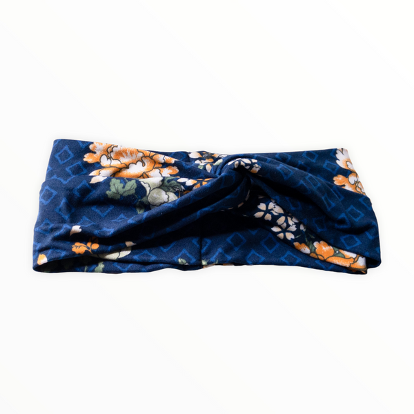 "Navy blue headband, light blue diamond outline shapes on double brushed polyester knit fabric, flowers are combination of golden yellow and white."